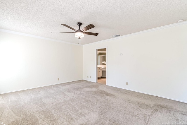 carpeted spare room with a textured ceiling, ceiling fan, and ornamental molding