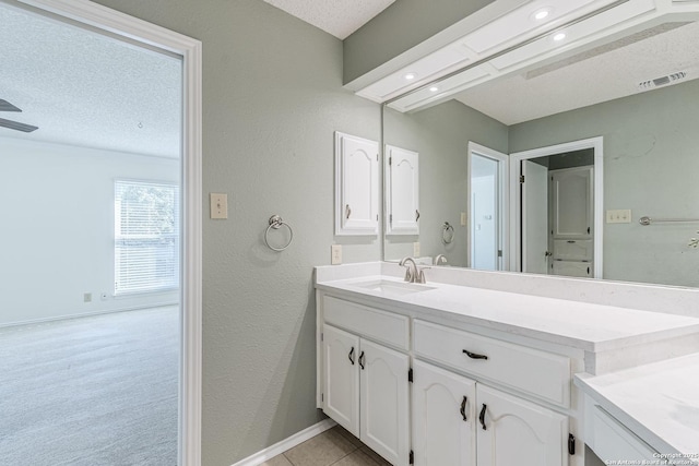 bathroom with vanity and a textured ceiling