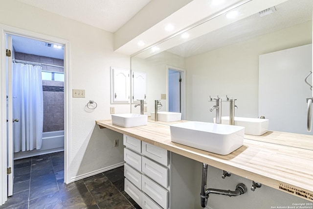 bathroom with vanity, a textured ceiling, and shower / bathtub combination with curtain