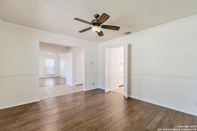 spare room featuring a textured ceiling, ceiling fan, light hardwood / wood-style flooring, and crown molding