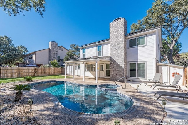 view of pool with ceiling fan, an in ground hot tub, and a patio area