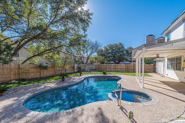 view of pool featuring a patio area and an in ground hot tub