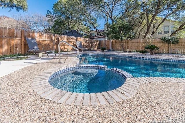 view of swimming pool with a patio and an in ground hot tub