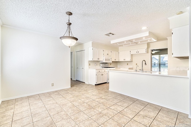 kitchen with hanging light fixtures, range with gas cooktop, kitchen peninsula, white cabinets, and sink