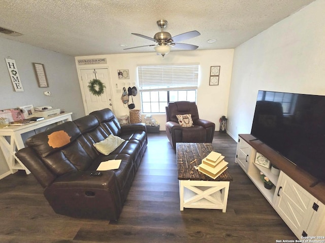 living room featuring a textured ceiling, ceiling fan, and dark hardwood / wood-style flooring