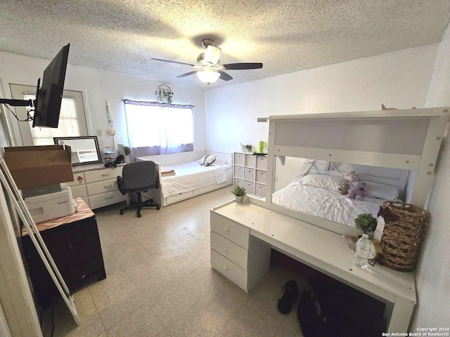 bedroom with a textured ceiling and ceiling fan