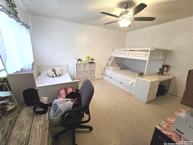 bedroom with ceiling fan and a textured ceiling