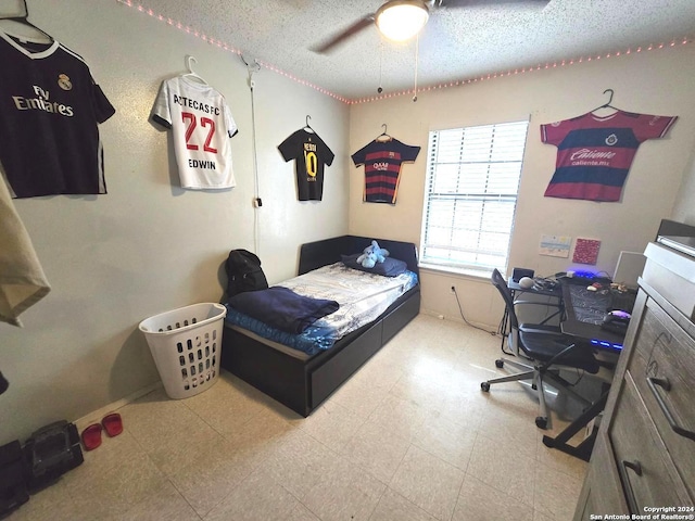 bedroom with a textured ceiling and ceiling fan