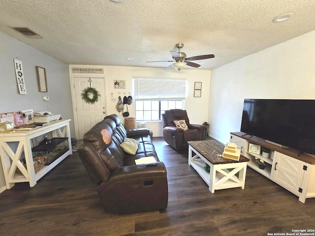 living room with ceiling fan, a textured ceiling, and dark hardwood / wood-style flooring