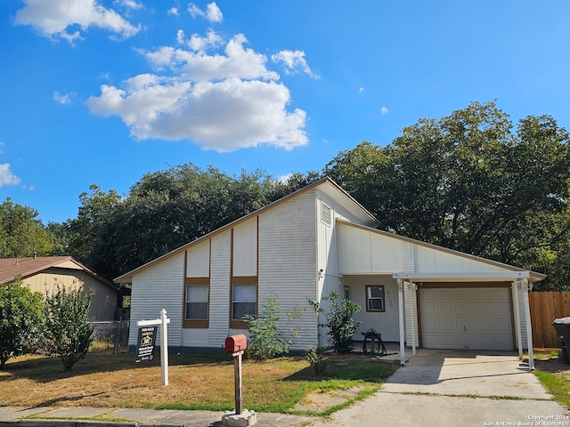 view of front of home with a front yard and a garage