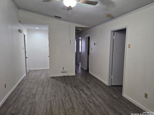 spare room featuring ceiling fan, a textured ceiling, and dark hardwood / wood-style flooring