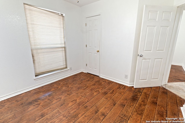 unfurnished room with dark hardwood / wood-style floors