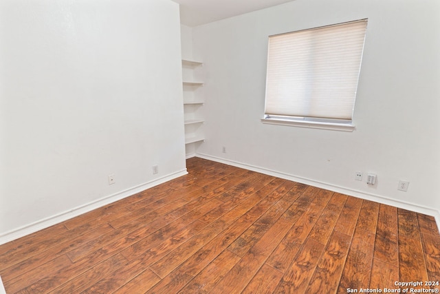 empty room featuring dark wood-type flooring