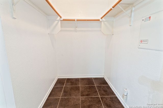 walk in closet with dark tile patterned flooring