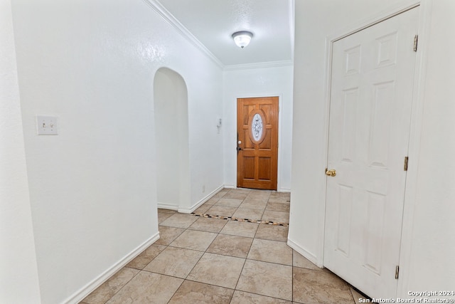 foyer entrance featuring ornamental molding and light tile patterned floors