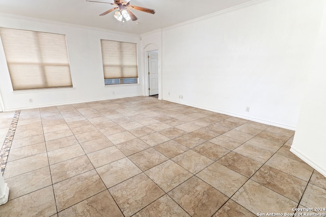 empty room featuring ornamental molding and ceiling fan