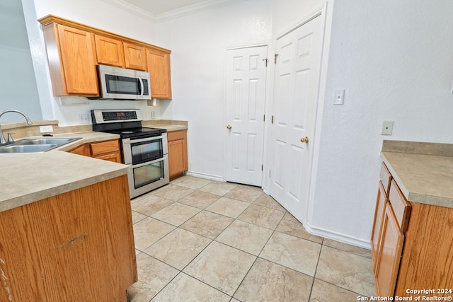 kitchen with ornamental molding, sink, and appliances with stainless steel finishes