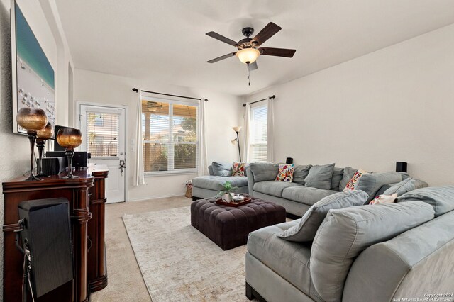 carpeted living room with ceiling fan