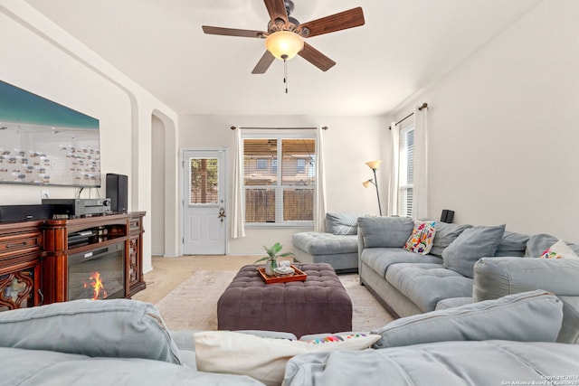 living room with ceiling fan and light colored carpet