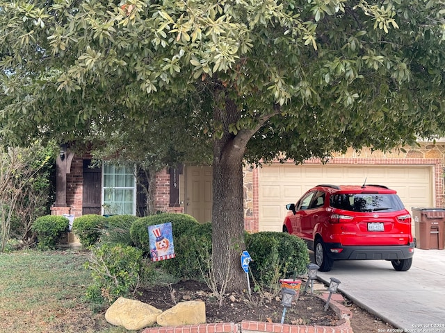 obstructed view of property with a garage