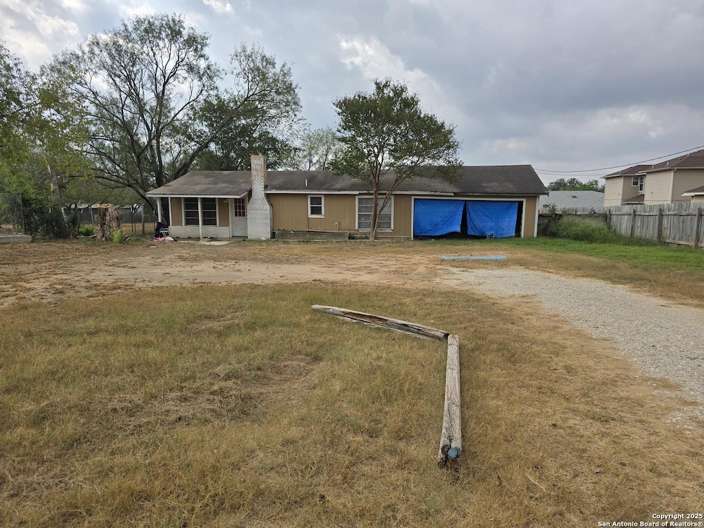 view of front of property featuring a garage and a front lawn