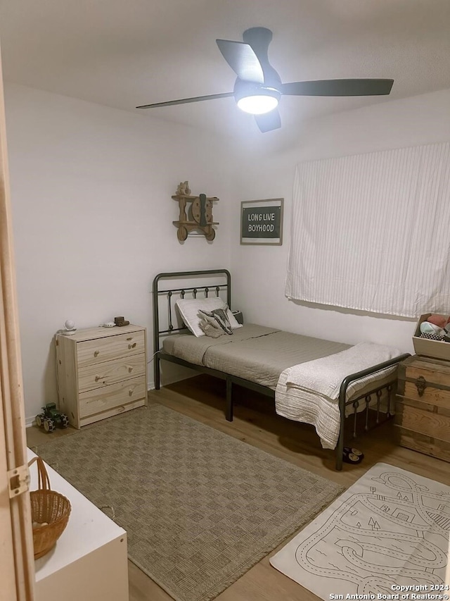 bedroom with light hardwood / wood-style floors and ceiling fan