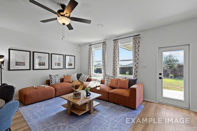 living room with wood-type flooring and ceiling fan