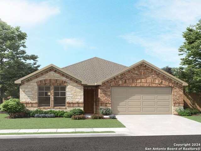 view of front of home with a front yard and a garage