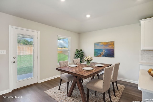 dining area featuring dark wood-type flooring