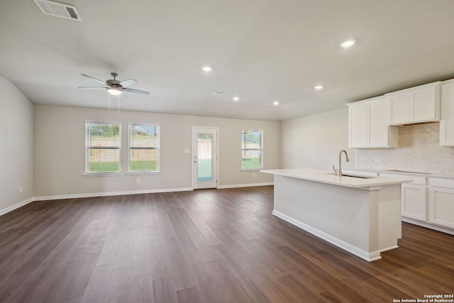 kitchen featuring dark hardwood / wood-style flooring, a center island with sink, a wealth of natural light, and sink