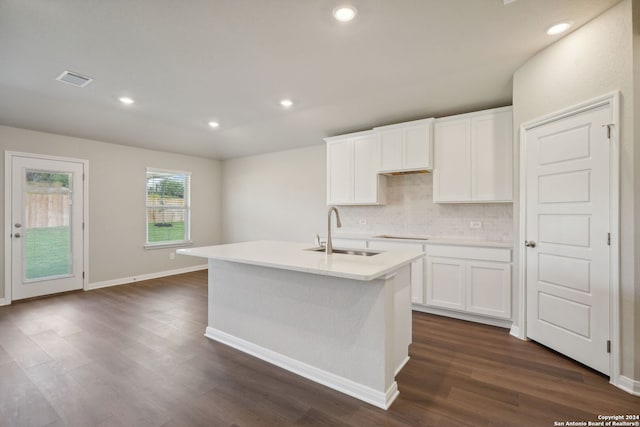 kitchen with white cabinets, sink, an island with sink, and dark hardwood / wood-style floors