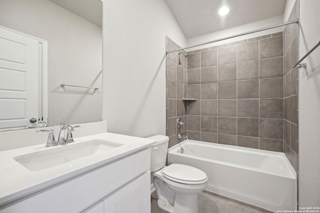 full bathroom with tile patterned flooring, toilet, vanity, and tiled shower / bath