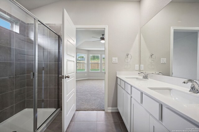 bathroom featuring tile patterned floors, vanity, a shower with door, ceiling fan, and lofted ceiling