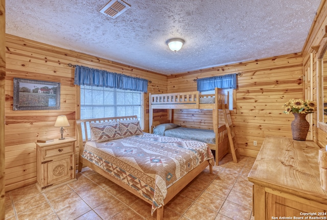 tiled bedroom with wood walls and a textured ceiling