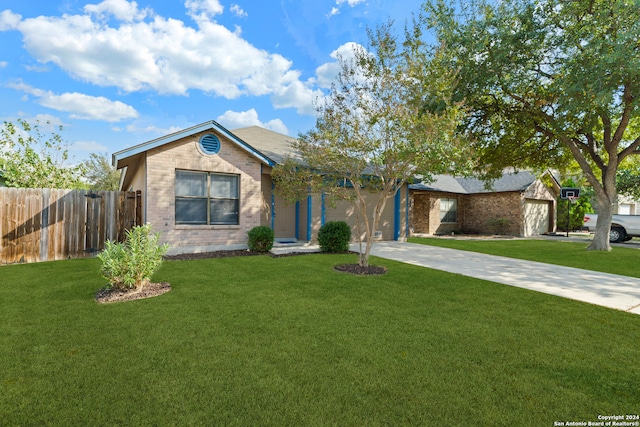 ranch-style house featuring a garage and a front lawn