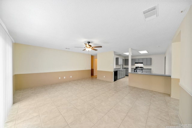 unfurnished living room featuring ceiling fan and light tile patterned floors