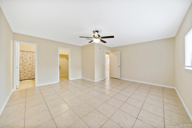 spare room featuring ceiling fan and light tile patterned flooring