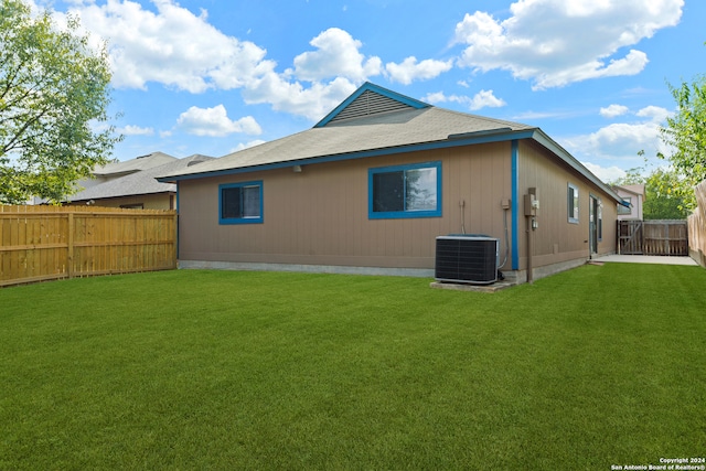 back of house featuring central air condition unit, a yard, and a patio area