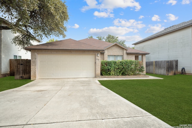 ranch-style home featuring a front yard and a garage