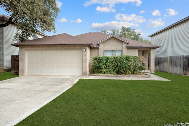 view of front of house with a garage and a front yard