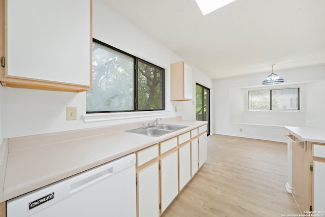 kitchen with white cabinets, a wealth of natural light, hanging light fixtures, and white dishwasher