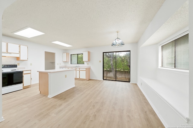 kitchen with white electric range oven, decorative light fixtures, light hardwood / wood-style flooring, a kitchen island, and exhaust hood