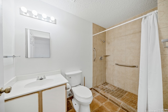 bathroom with walk in shower, vanity, a textured ceiling, tile patterned flooring, and toilet