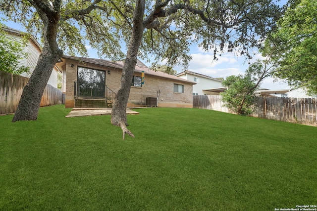 back of house with a yard