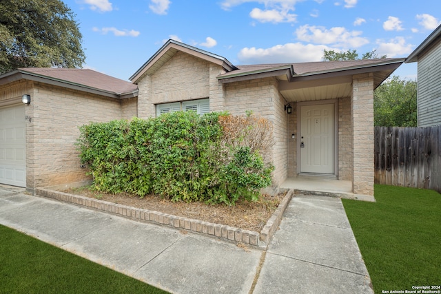 view of front of property with a garage and a front lawn