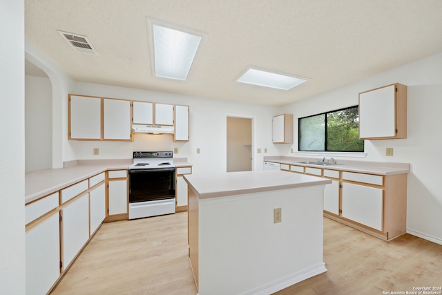 kitchen featuring a kitchen island, white cabinetry, white appliances, and light hardwood / wood-style floors