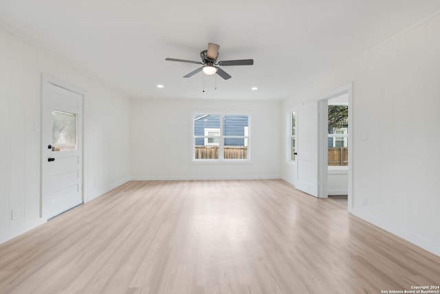 unfurnished room featuring ceiling fan, light hardwood / wood-style floors, and a healthy amount of sunlight