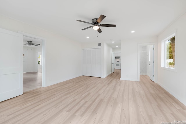 unfurnished living room featuring light hardwood / wood-style flooring and ceiling fan