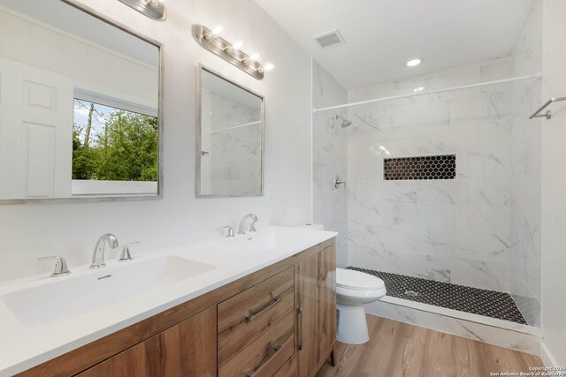 307 Bexar Dr, San Antonio, TX 78228 - full bath featuring toilet, a marble finish shower, double vanity, and wood finished floors