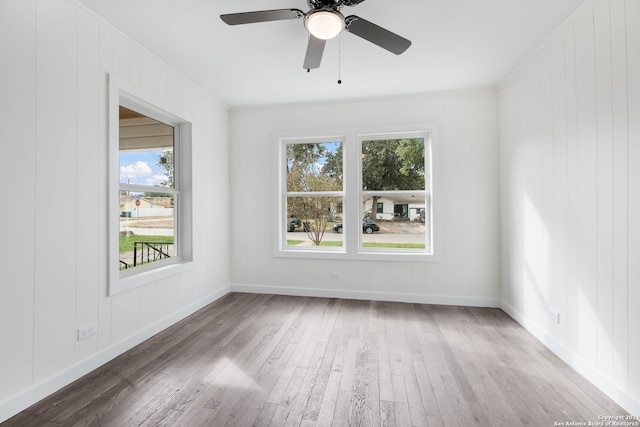 spare room featuring hardwood / wood-style floors and ceiling fan